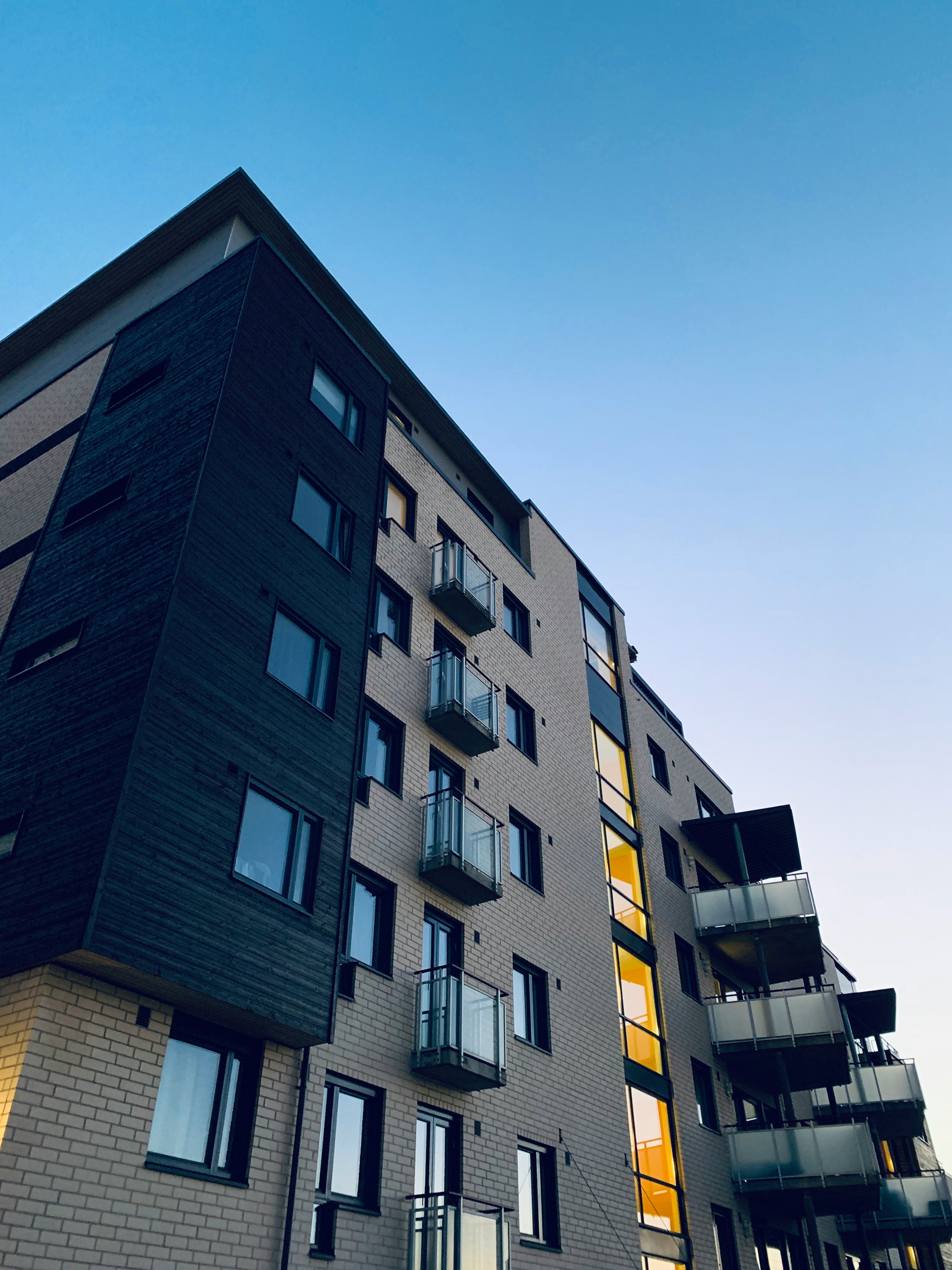 Low-angle photo of a modern high-rise apartment building
